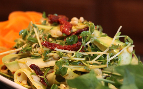 Raw zucchini pasta with sun-dried tomatoes and nuts