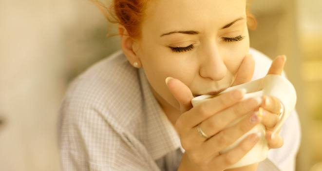 good morning womans with cup of fragrant coffee on balcony